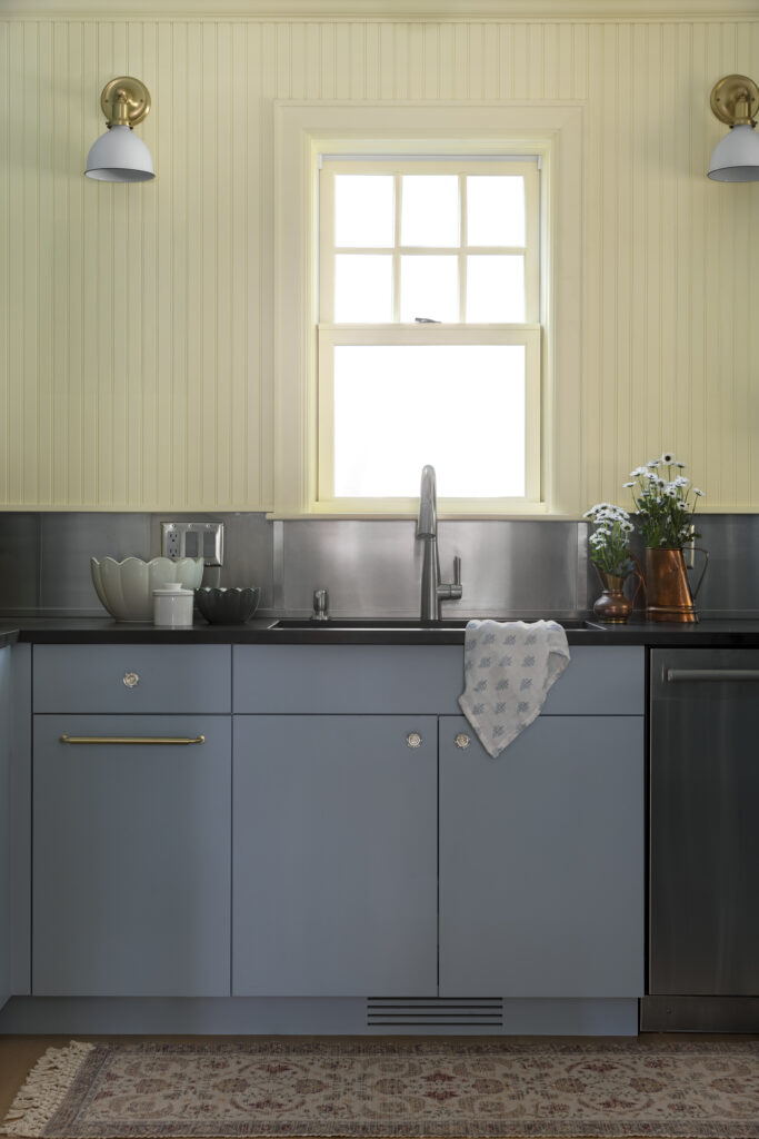 Minneapolis scullery, light blue cabinetry, yellow walls, ovens, sink, dishwasher, magnetic backsplash