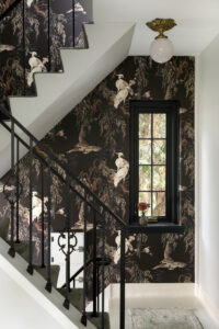 Dramatic wallpaper in a Minneapolis stairway helps protect the walls.